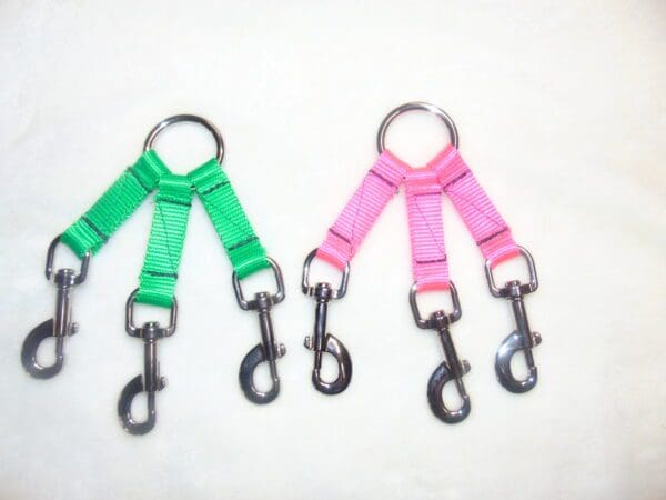 Two different colored dog leashes with a metal ring.