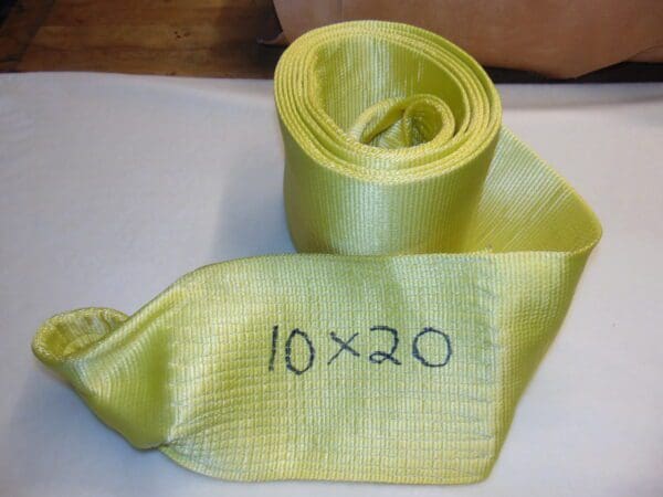 A yellow tie with the words " 1 0 x 2 0 ".