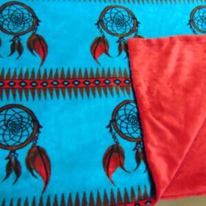 A blanket with red and blue feathers on it