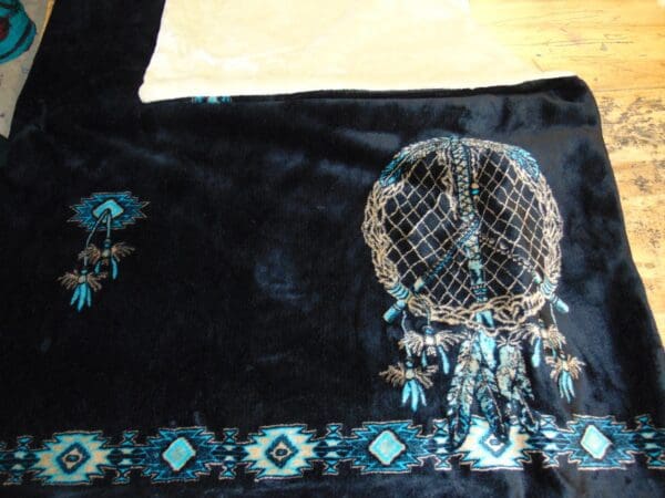 A close up of the blanket with a dreamcatcher on it