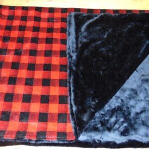 A red and black plaid blanket with a black diamond design.