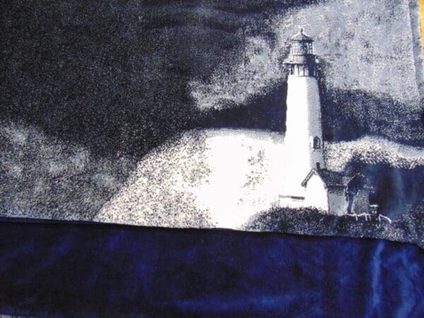 A painting of a lighthouse with the light on.