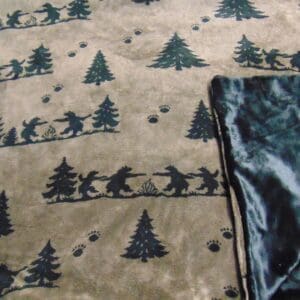 A blanket with trees and bears on it