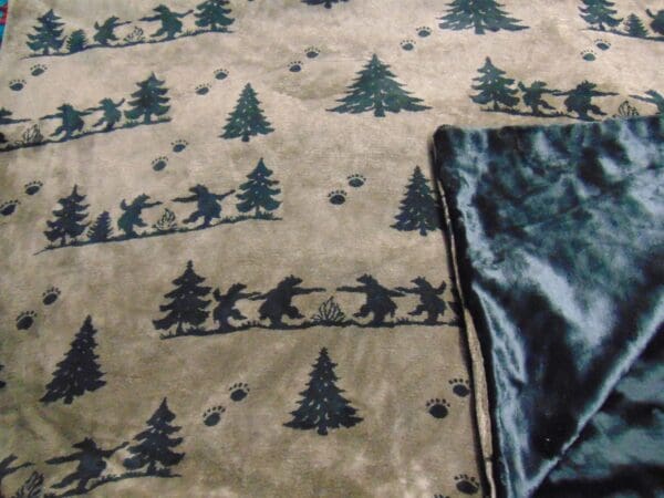 A blanket with trees and bears on it