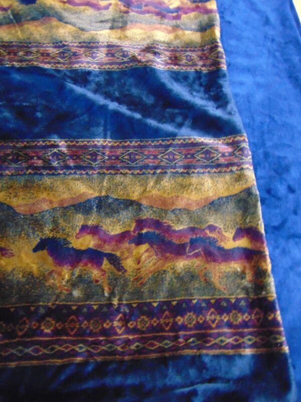 A close up of the horses on the blanket