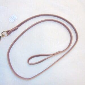 A brown leather leash with a metal clip.