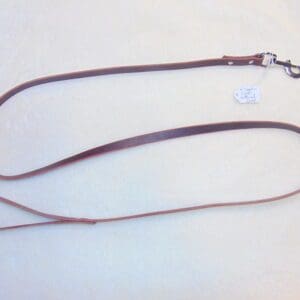 A brown leather leash with a silver clip.