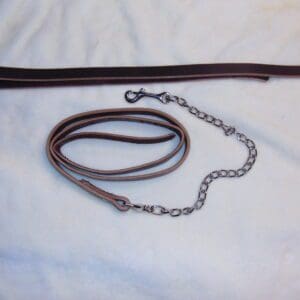 A brown leather leash with chain attached to it.