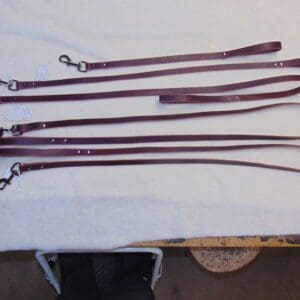 A table with several different types of leather straps.