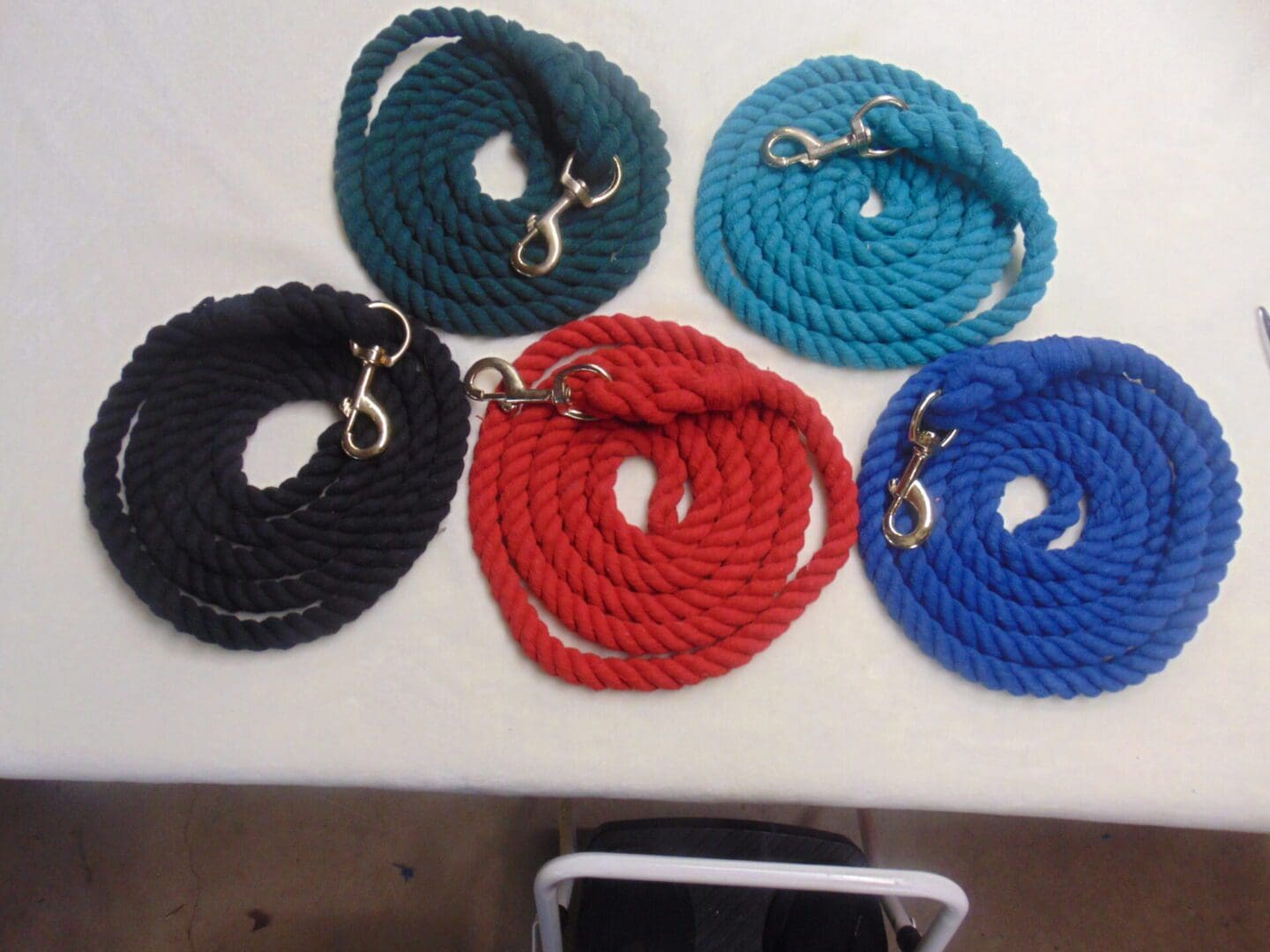 A table with five different colored ropes on it.