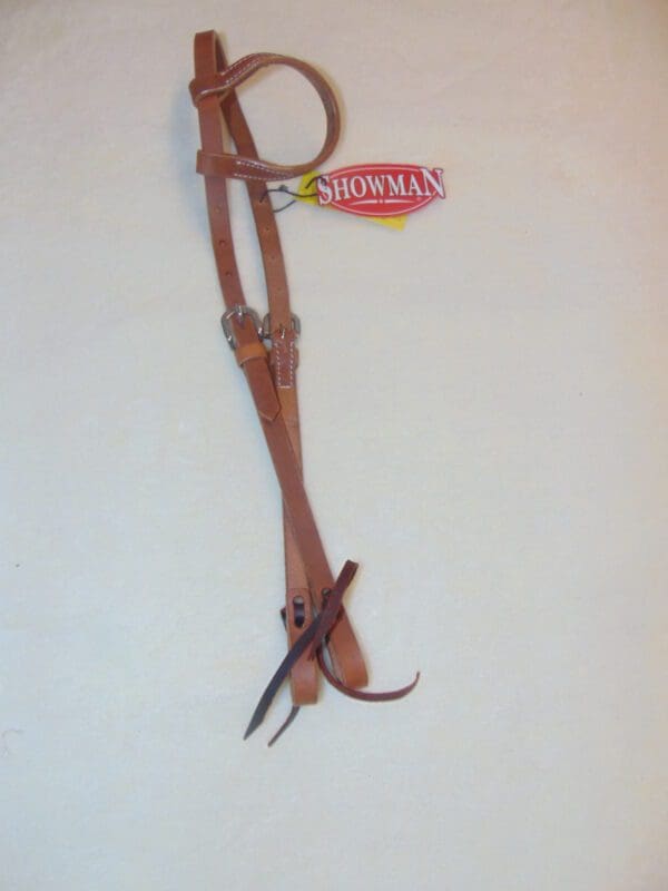 A pair of brown leather horse reins with a tag hanging from the side.