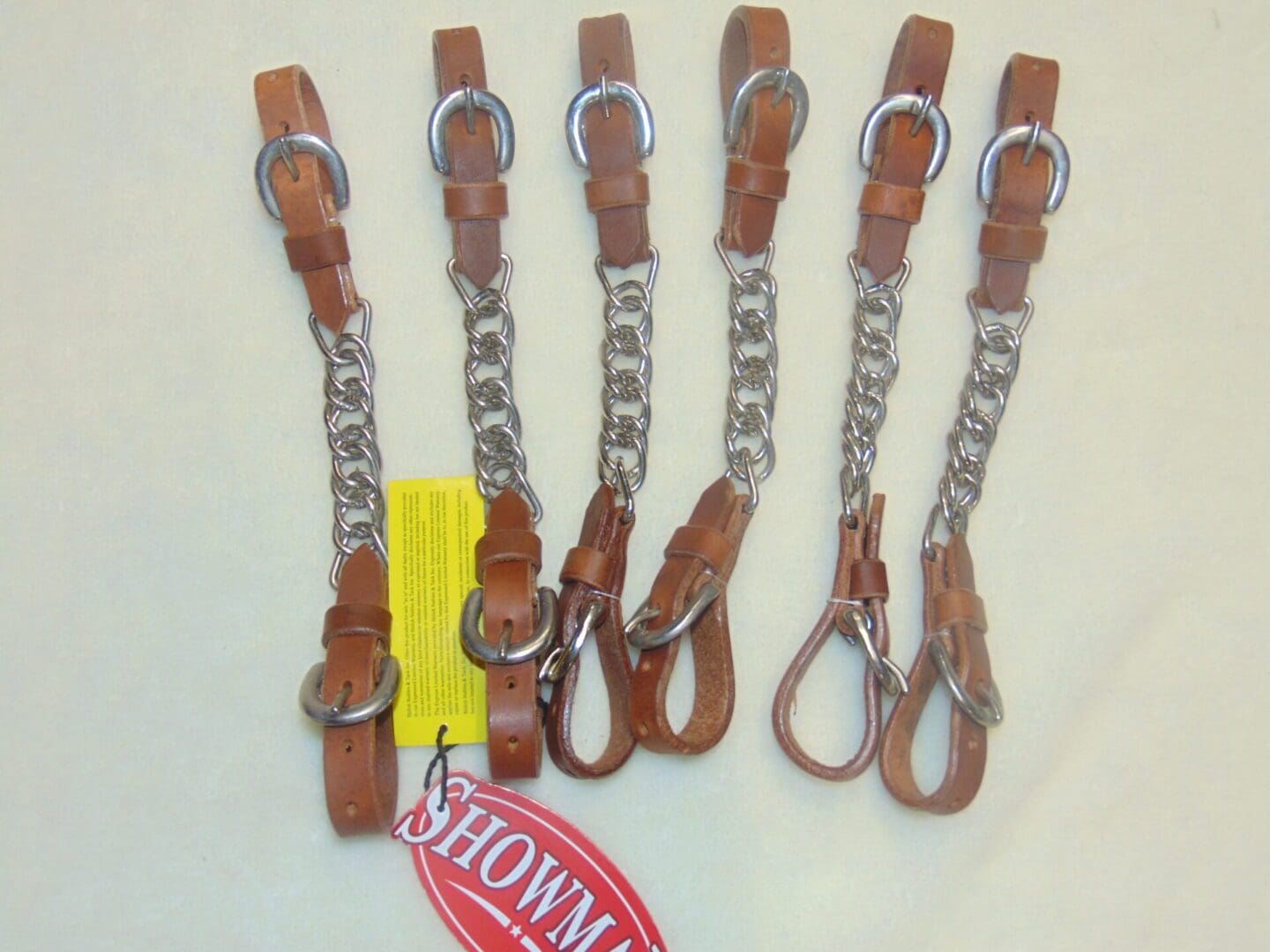 A set of six pairs of brown leather horse bit.